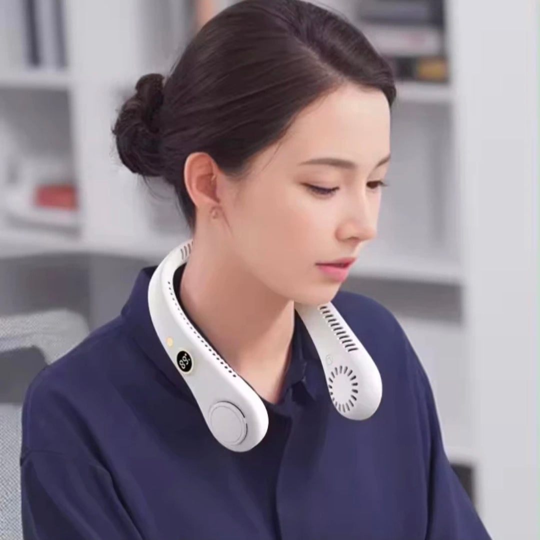 Woman wearing a white portable neck fan device in an office setting